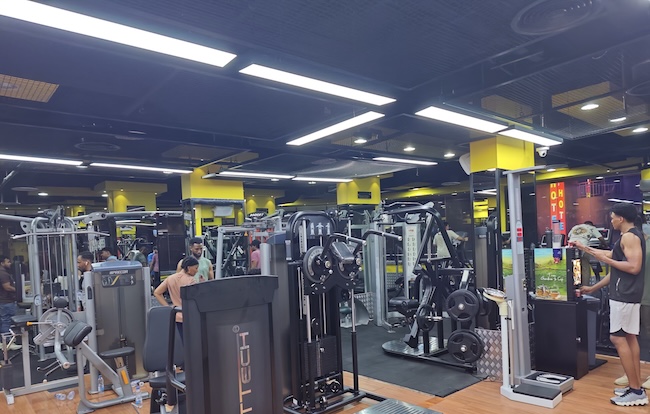 NOVRAXA gym equipment procurement guide showing a treadmill, chest press, and functional trainer with English and Arabic labels. NOVRAXA gym equipment procurement guide showing a treadmill, chest press, and functional trainer with English and Arabic labels.