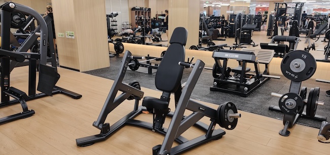 NOVRAXA gym equipment procurement guide showing a treadmill, chest press, and functional trainer with English and Arabic labels. NOVRAXA gym equipment procurement guide showing a treadmill, chest press, and functional trainer with English and Arabic labels.