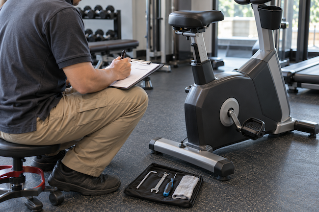 Adjustable bench beside a dumbbell rack and weight plate storage tree. Adjustable bench beside a dumbbell rack and weight plate storage tree.